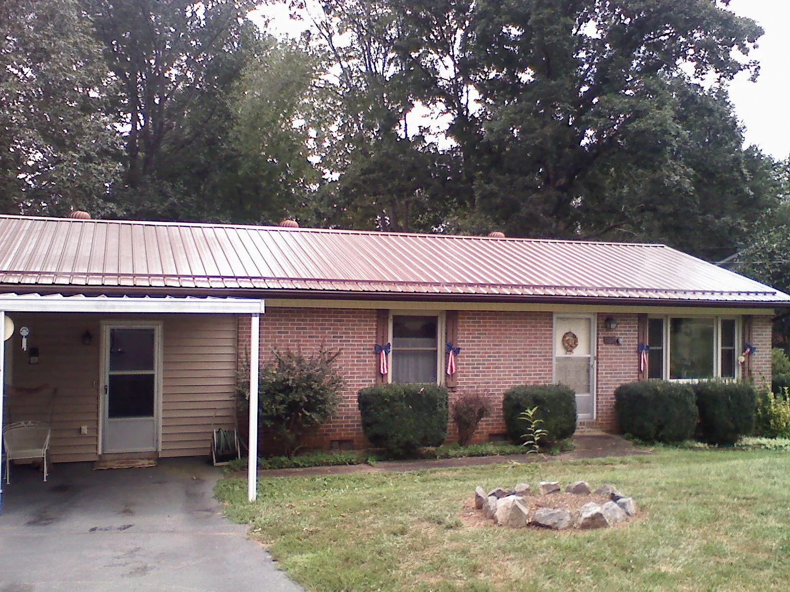 Bronze metal roof and carport on a brick ranch home — Roof Repair work by our crew in Huntington Beach